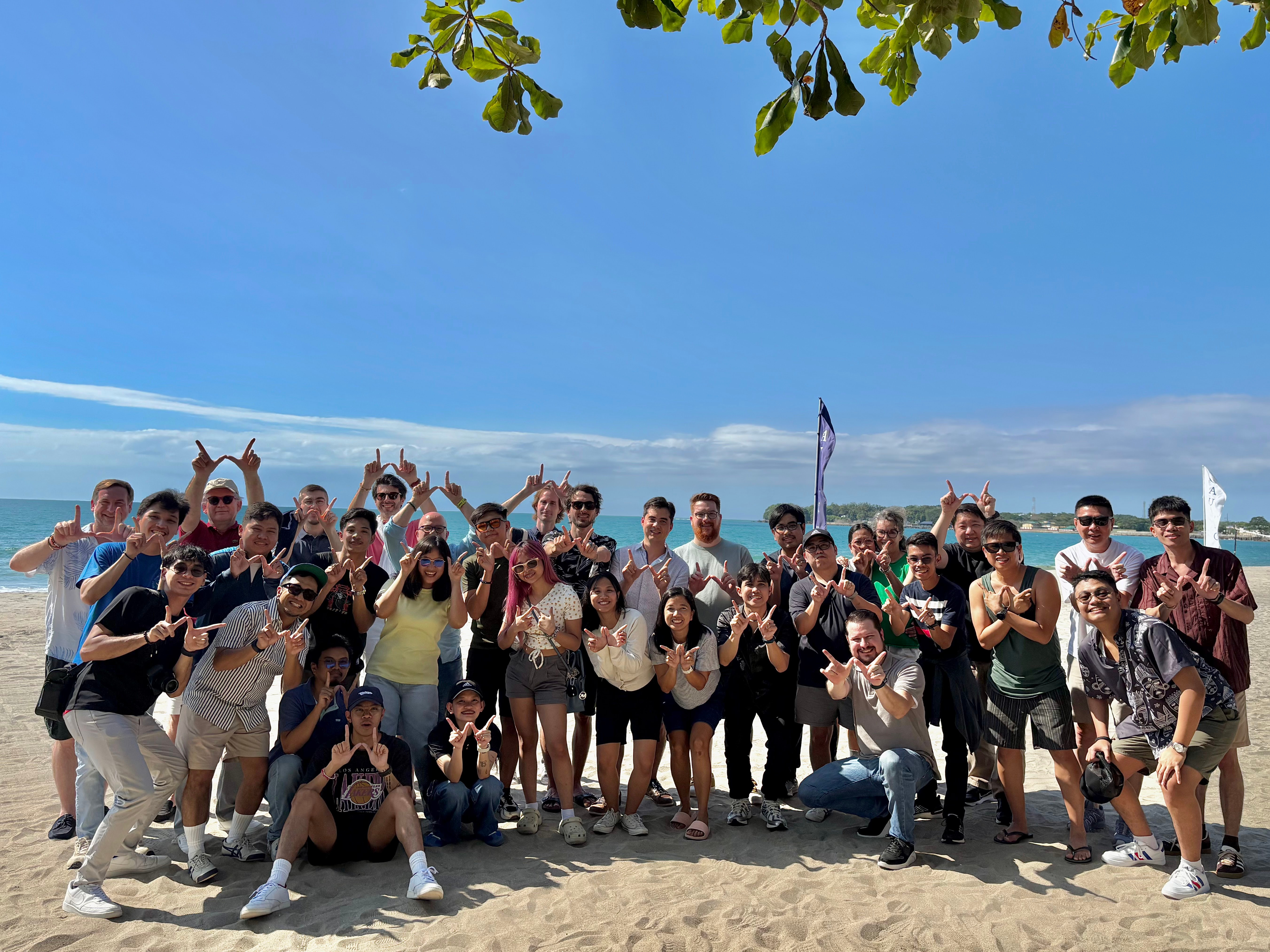 Wizy team standing together on a beach